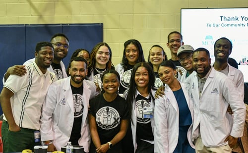 A group of students and young adults gather at Black Men in White Coats Youth Summit: Milwaukee