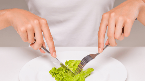 A person cuts a small serving of lettuce, presented with the question 