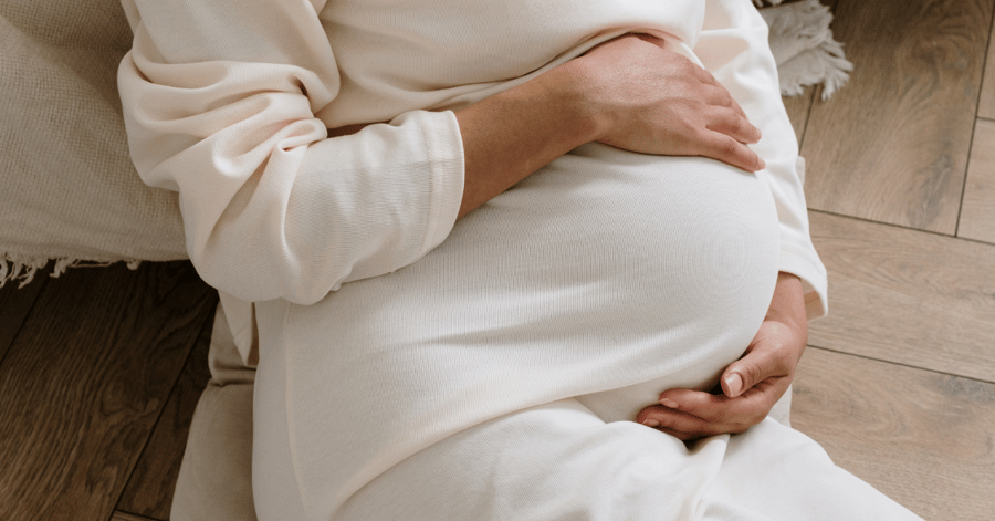 The feature image for this blog about maternal health depicts a pregnant woman holding her belly.