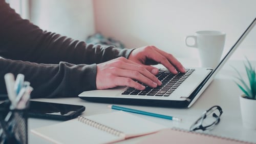 Hands type on a keyboard 