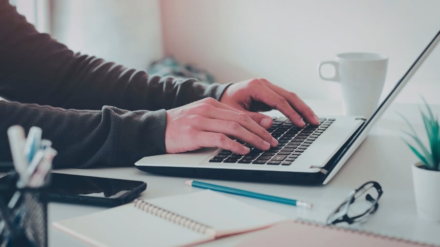 Hands type on a keyboard 