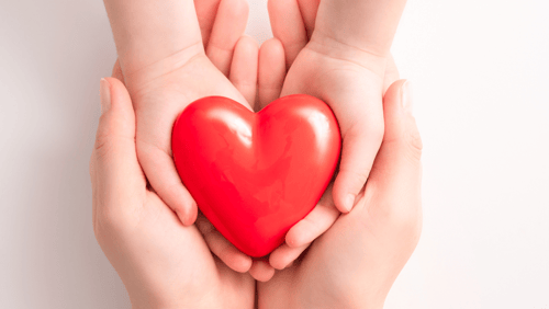 A child's hands hold a heart. Health research funding from AHW is supporting children's health in Wisconsin.