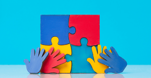 Hands build a puzzle; AHW Community Health Grant Helps Reduce Autism Diagnoses Bottleneck