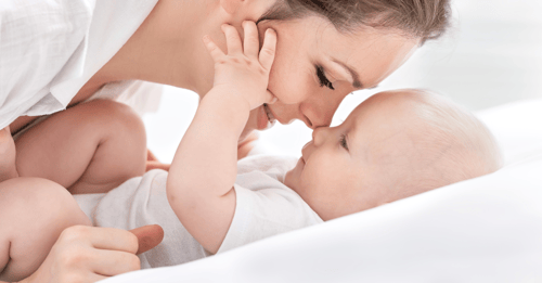 A mother snuggles her baby. In this blog, AHW discusses maternal mental health month and related community health grants in Wisconsin.