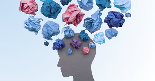 A silhouette of a person's head with paper-clouds, representing mental health.