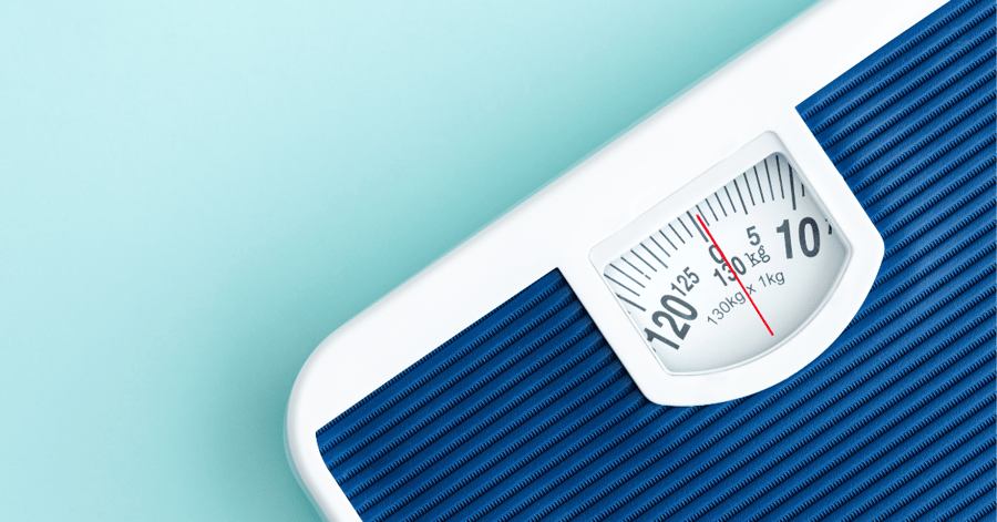 A body weight scale displays a number; AHW shares the science behind losing weight.