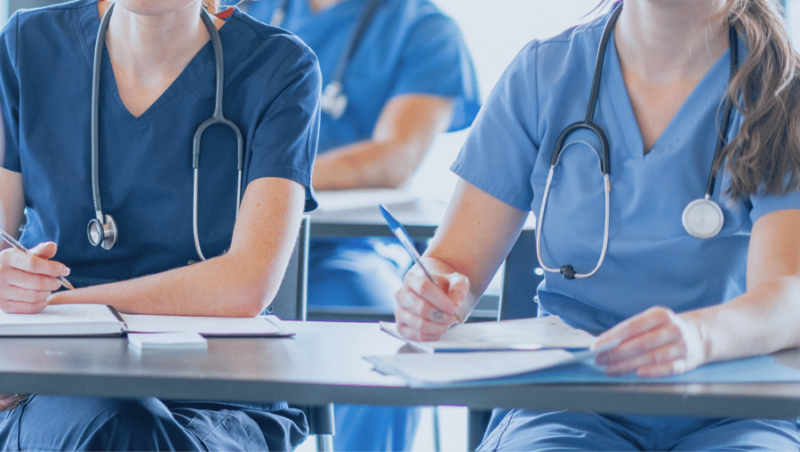 Medical students sit in class and take notes.