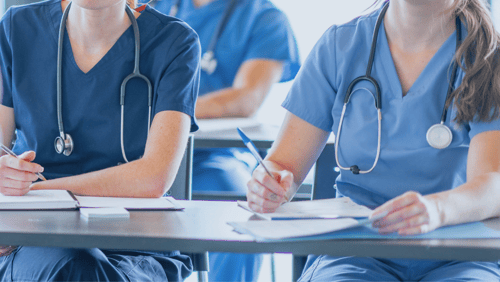 Medical students sit in class and take notes.