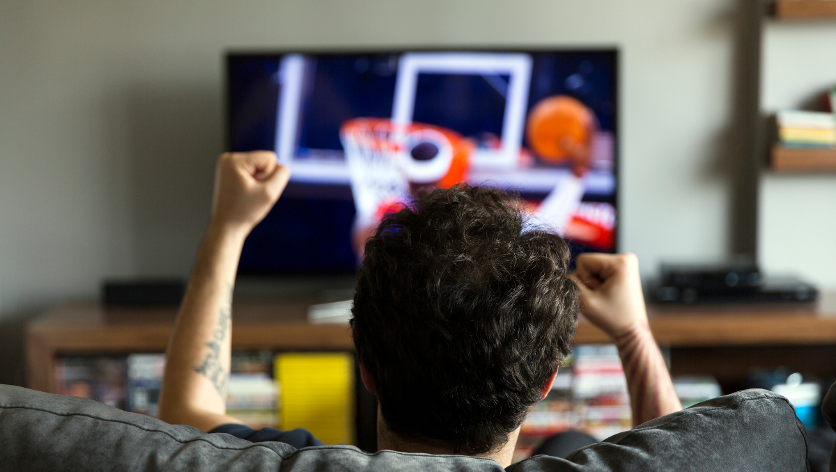 A man watches March Madness while recovering from Vasectomy Surgery. AHW Endowment shares the science behind the procedure in this blog post.