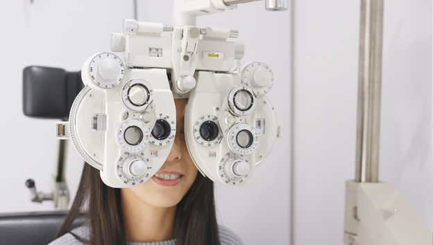 a woman is given a vision exam. health research funding is increasing access to this sort of crucial vision health care in Wisconsin.